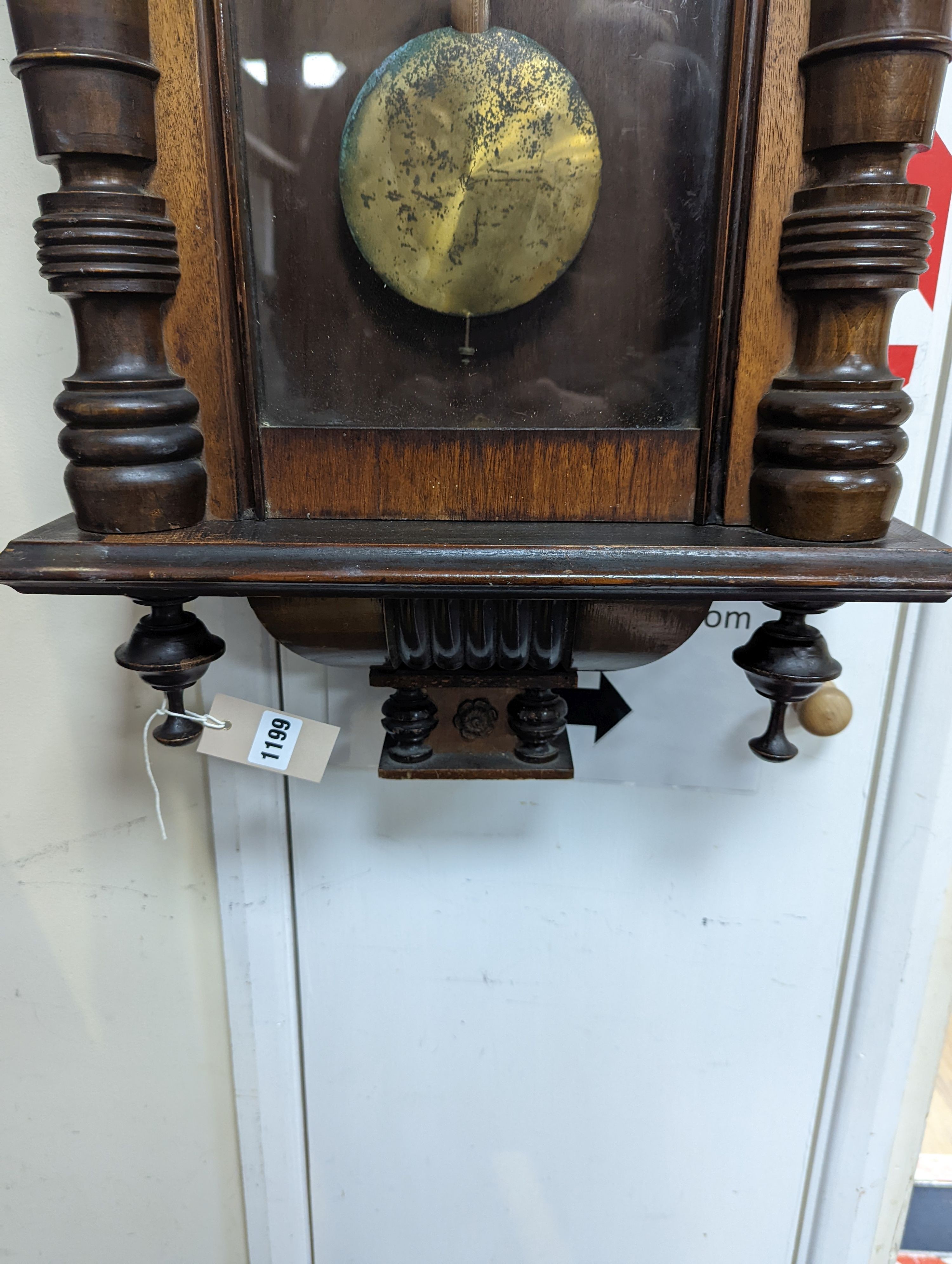 A late 19th century Austrian walnut wall clock, with key and pendulum, height 118cm